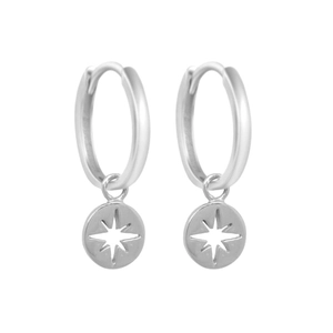 Detail of silver S925 north star hoop earrings with circular starburst coin pendants