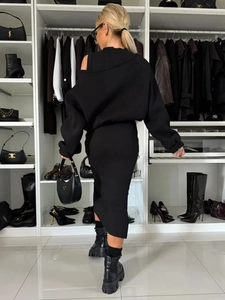 Detail of black off-shoulder two-piece skirt set with long sleeves and slim-fit hem