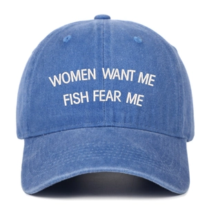 Detail of embroidered Women Want Me Fish Fear Me slogan on navy blue washed denim cap