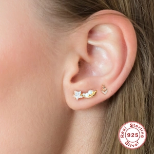 S925 sterling silver gold ear cuff with pearls and stars shown on a model's ear