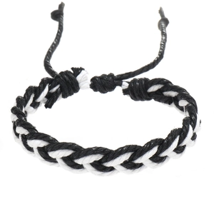 Detail of adjustable black and white braided cotton rope bracelet with woven texture