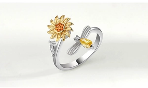 Detailed close-up of a silver sunflower spinner ring with gold bees and zircon stones