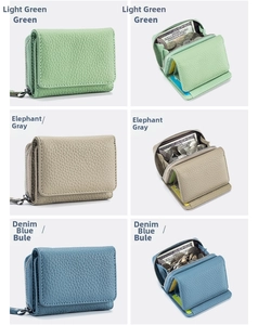 Detail view of mini RFID trifold leather wallets in green, grey, and blue with lychee texture