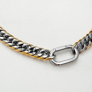 Close-up of 9mm two-tone Cuban link necklace with industrial carabiner clasp