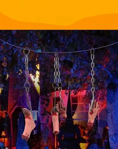 Detailed view of bloody severed hand and foot props with metal hooks for haunted house decor