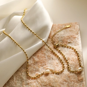 Minimalist 18K gold plated bead necklace featuring dual baroque pearls on silk fabric