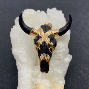 Macro view of luxury bull head acrylic pendant with gold plating and black finish