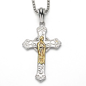 Macro detail of a silver Celtic cross pendant with ornate carvings and a gold figure