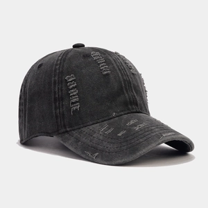 Vintage washed black distressed baseball cap with ripped details and retro street style