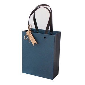 Elegant navy blue gift bag with black handles and a rustic Thank You kraft tag label