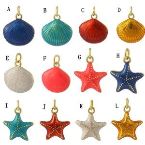 Selection of colorful 18k gold plated shell and starfish charms in a grid labeled A-L