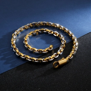 Detail of gold and silver hiphop link chains on a blue and black textured background