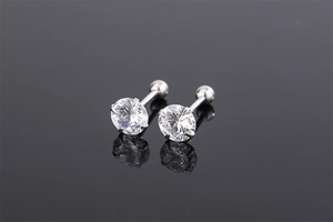 Detailed macro view of silver four-prong cubic zirconia studs with screw-back design