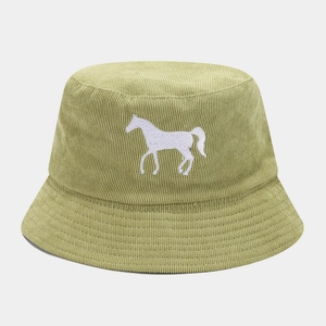 Close-up of white horse embroidery on green corduroy bucket hat texture and stitching