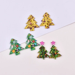 Detailed view of festive Christmas tree acrylic pendants with glitter and Santa patterns