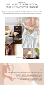 Detailed view of luxury white silk slip dress with delicate lace trim and pearl necklace
