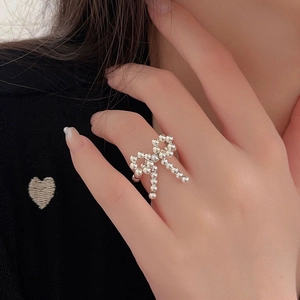 Elegant S925 sterling silver beaded ring featuring a bow knot design worn on finger