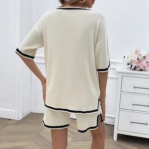 Women's beige knit two-piece set with black striped trim showing the back view