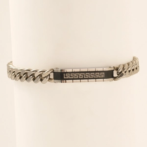 Detail of silver stainless steel Cuban link bracelet with black Greek Meander pattern