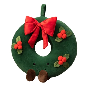 Plush Christmas wreath toy with red bow and berries on white background for holiday decor