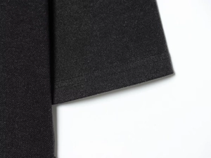 Detail shot of double-needle stitching and fabric texture on a black slim dress