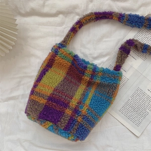 Detailed top view of a fuzzy plaid tote bag featuring bright purple and green wool textures