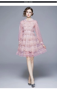 Détail de la robe en dentelle rose clair élégante avec crochet et jupe à plusieurs niveaux