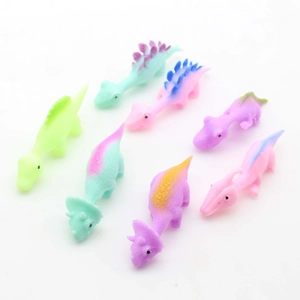 Set of 7 colorful dinosaur slingshot toys in bright pastel colors on white background