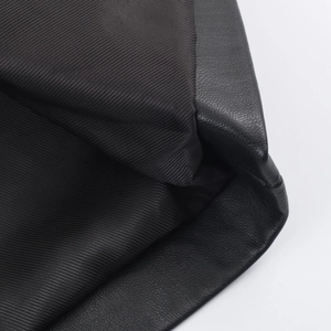 Macro detail of high-quality black leather texture and durable woven fabric lining