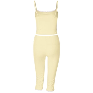 Close-up of pale yellow ribbed set featuring delicate white lace trim on the hem and straps