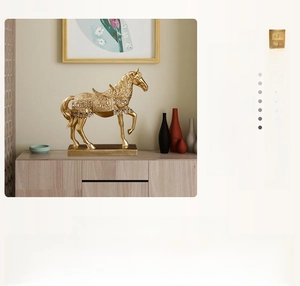 Close-up of golden resin horse statue on wooden cabinet showing durable texture