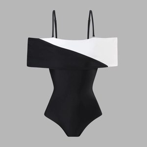 Detail of V-neck one-piece swimsuit featuring black and white contrast patchwork design