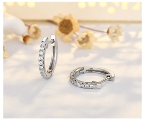 Macro shot of S925 sterling silver hoop earrings with white diamond pavé studs