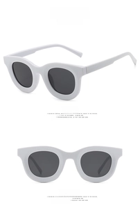 Front and side views of chunky white round oversized sunglasses with dark grey lenses
