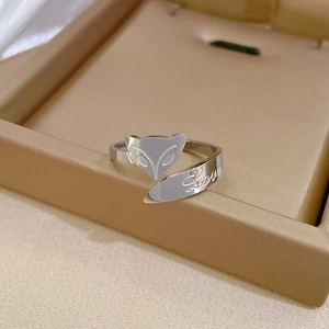 Detail of silver fox head ring with engraved Love letter on polished stainless steel