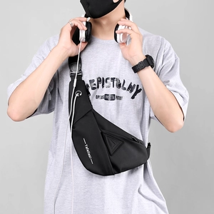 Detail of water-resistant black tactical chest bag with earphone port and buckle