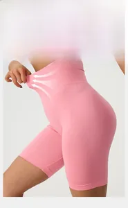 Detail shot showing the high elasticity and 4-way stretch of pink high waisted yoga shorts
