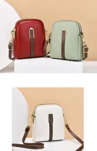 Detail view of small crossbody bags in various colors featuring double zipper compartments