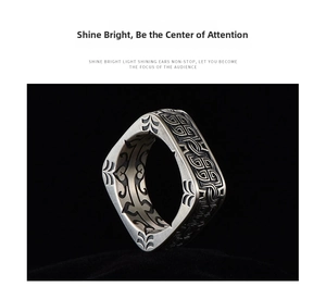 Detail of vintage silver ring featuring mechanical textures and dark leaf totem patterns
