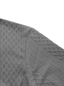 Macro shot of grey knitted men shirt showing fine diamond texture and shoulder seam details