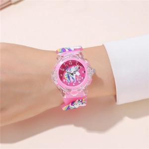 Close-up of kids pink quartz watch with unicorn and castle patterns on a child's wrist