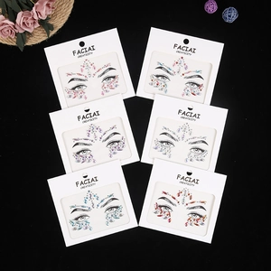 Flat lay of six colorful facial crystal gemstone sticker packs for festive party makeup