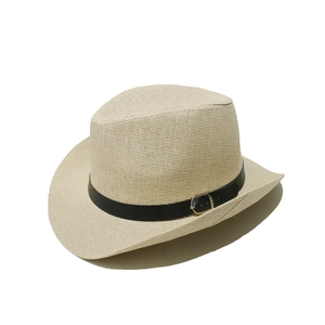Detailed texture of beige woven straw hat featuring a black leather band and metal buckle