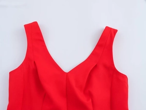 Close-up of a red V-neck dress featuring a smooth texture and refined tailoring details