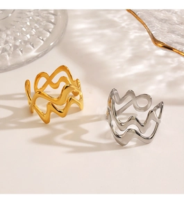Polished wavy stainless steel rings in gold and silver finish with light reflections