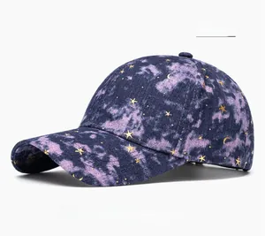 Detailed embroidery of gold stars and crescent moon on a blue-purple starry baseball cap