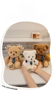 Three plush teddy bears with neckties shown in hand as cute backpack accessories