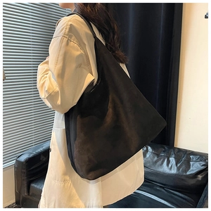 Fashionable black large capacity tote bag shown on model for daily commuting style