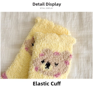 Detailed close-up of elastic cuffs on yellow coral fleece thermal socks for women