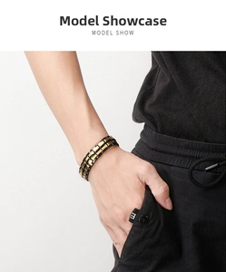 Close-up of black and gold magnetic therapy steel bracelet worn on a male wrist
